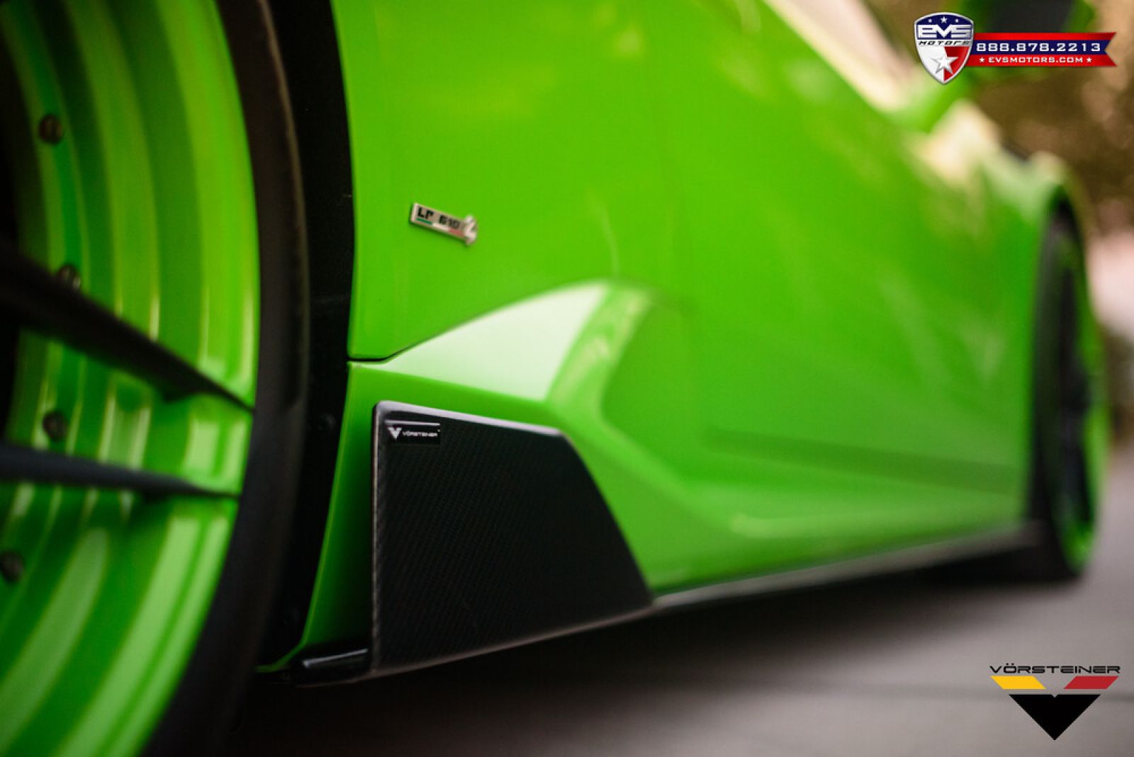 Close-up of green Lamborghini Huracan, showing the Vorsteiner logo.