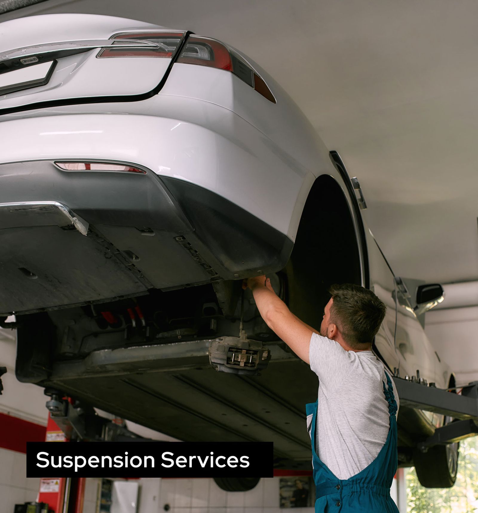 Car Mechanic Repairing Suspended Car's Wheels