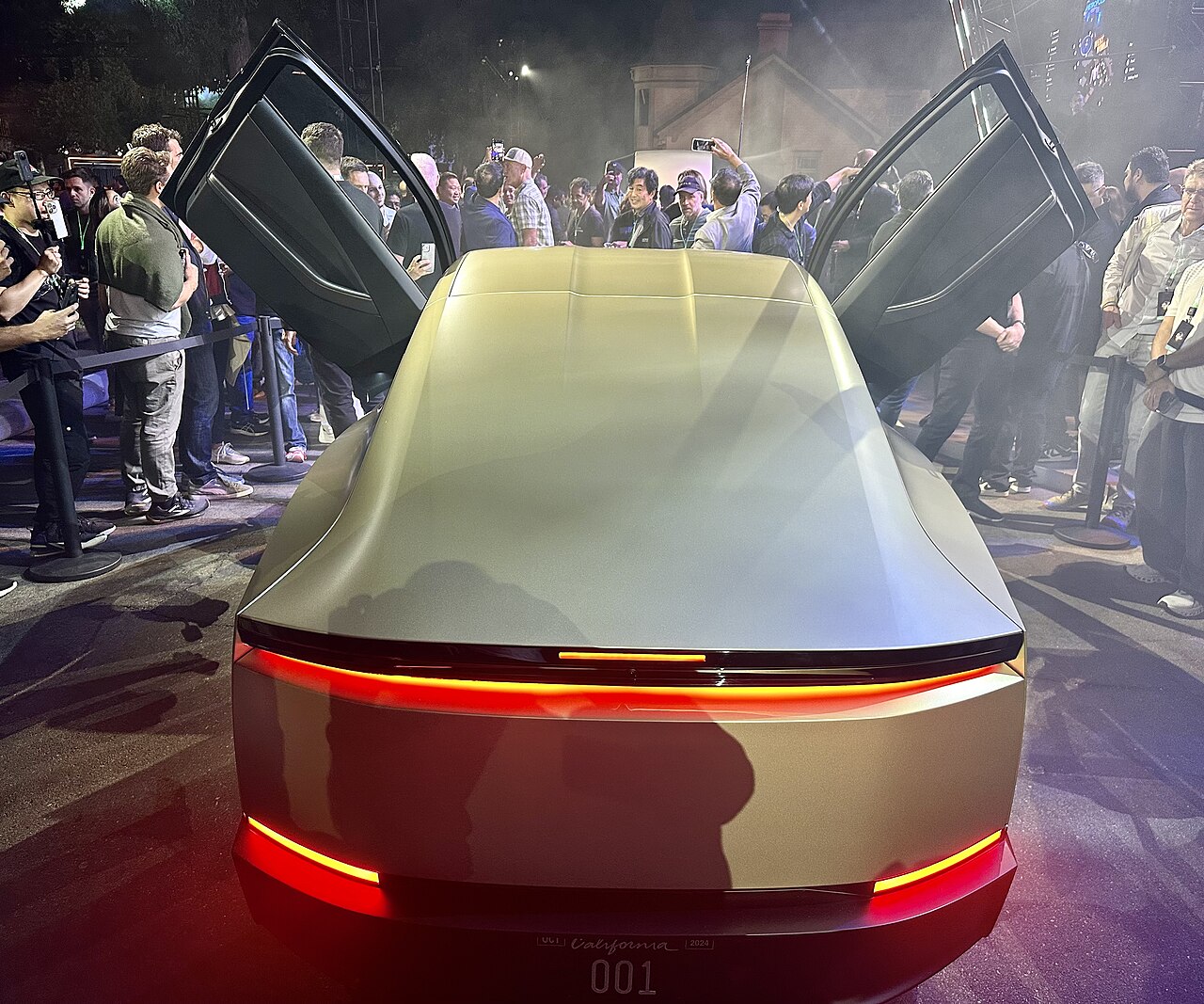 Rear view of the Tesla Cybercab liftback coupe with full-width LED light bar and no rear window