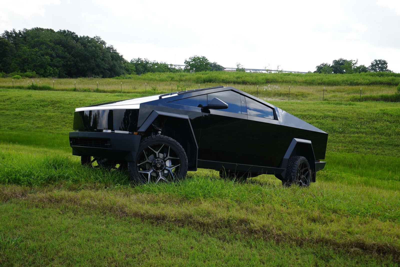 Gloss black lifted Cybertruck in field