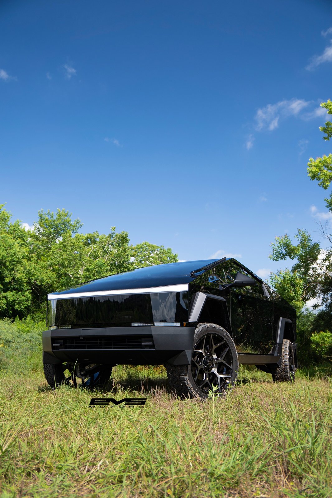 Gloss black Cybertruck in field with EVS watermark
