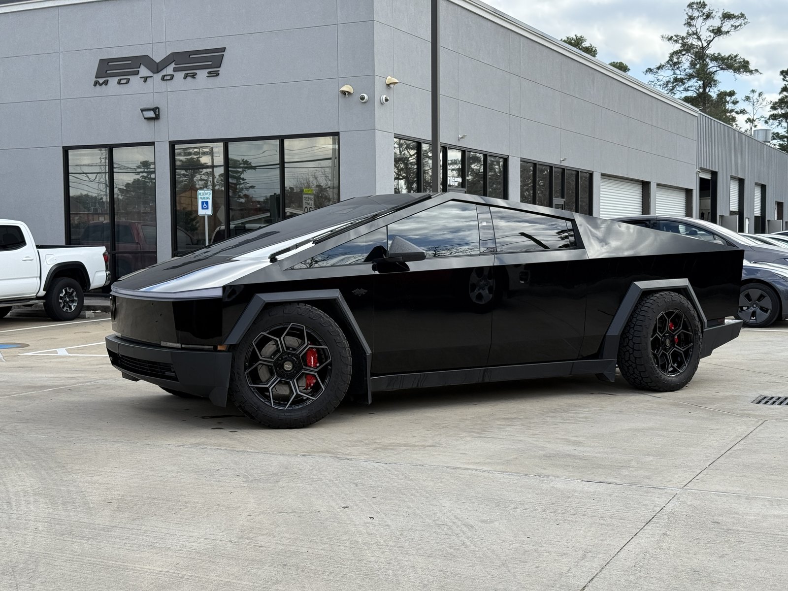Gloss black Cybertruck with flares and red calipers at EVS Motors