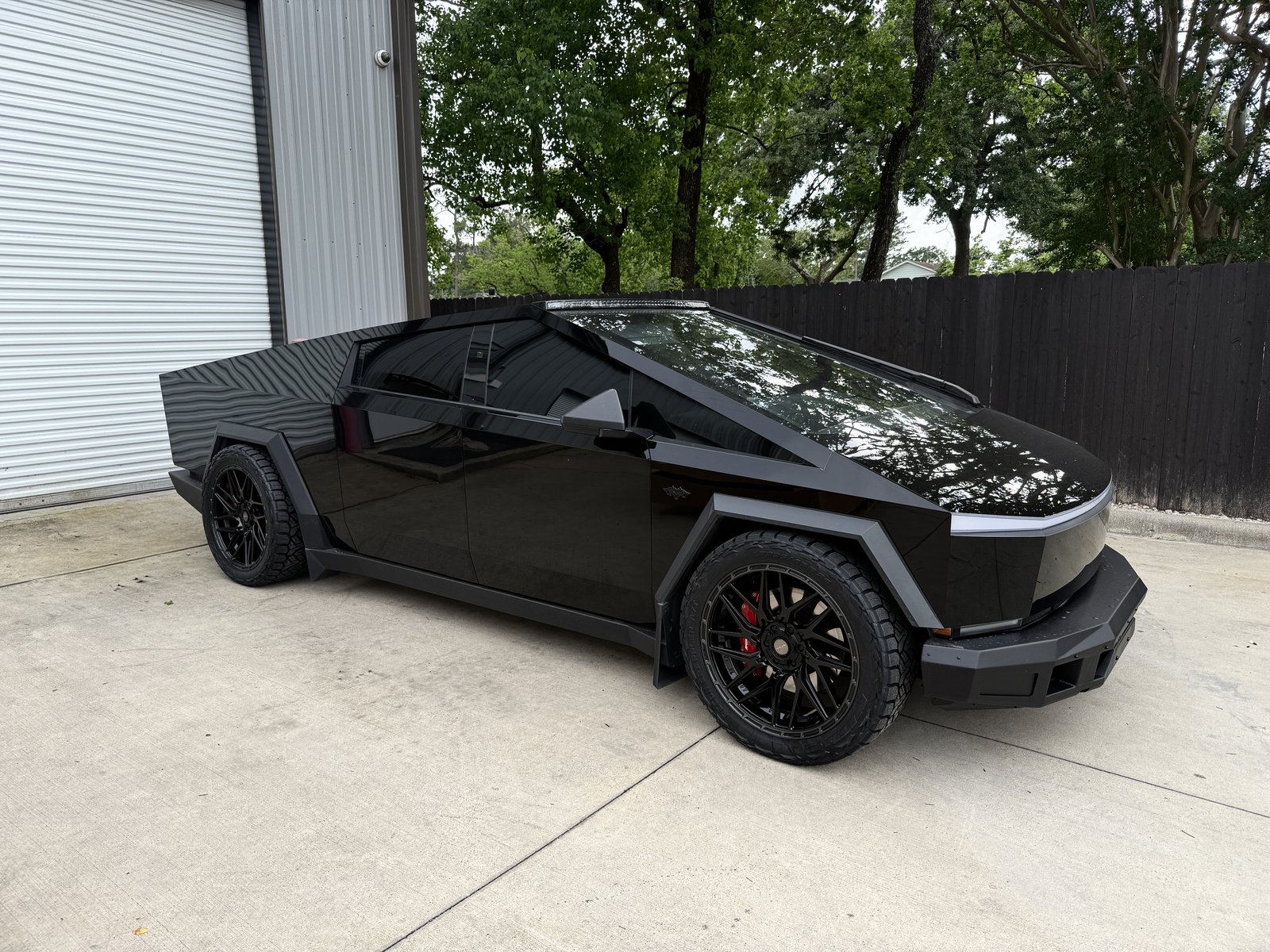 Gloss black Cybertruck with matte flares, bumper and light bar