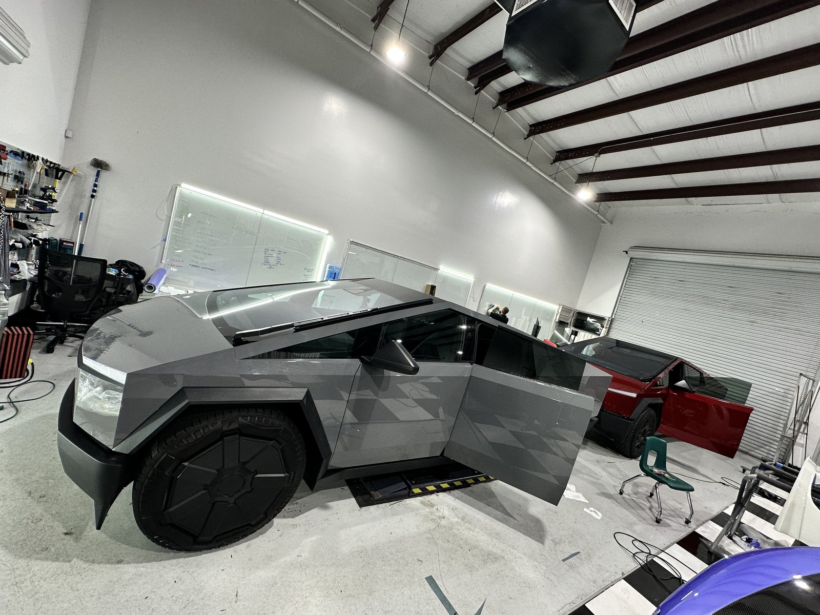Gray and red Cybertrucks in EVS shop