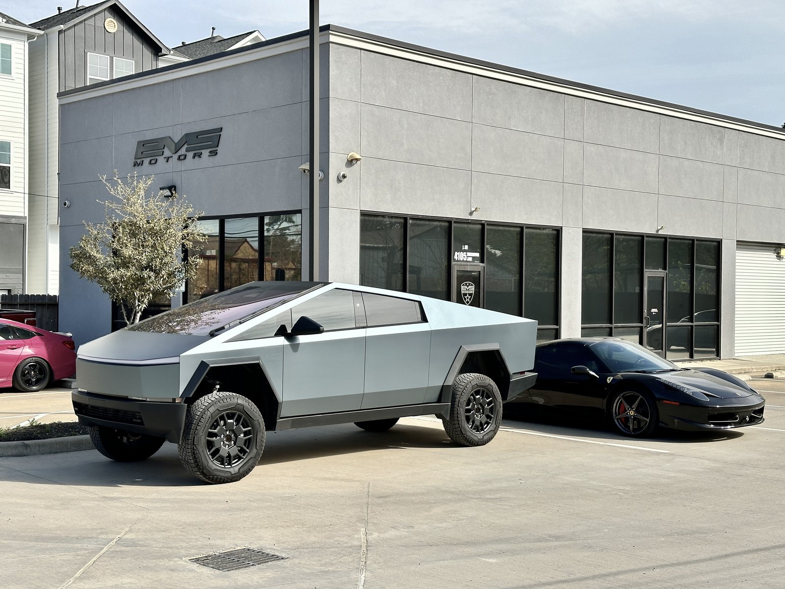 Lifted blue-grey Cybertruck with Ferrari at EVS