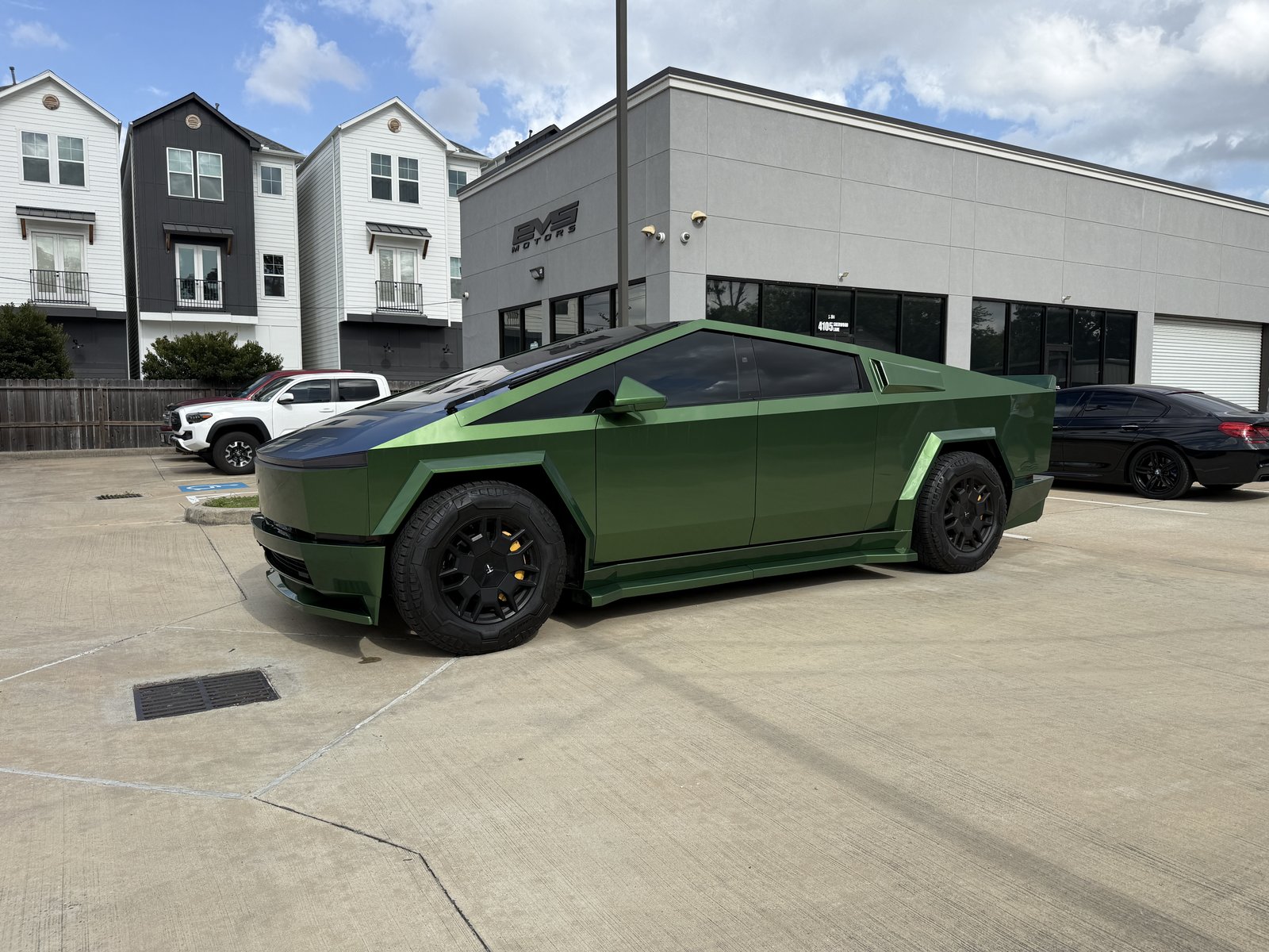 Olive green Cybertruck wrap with yellow calipers at EVS Motors Houston