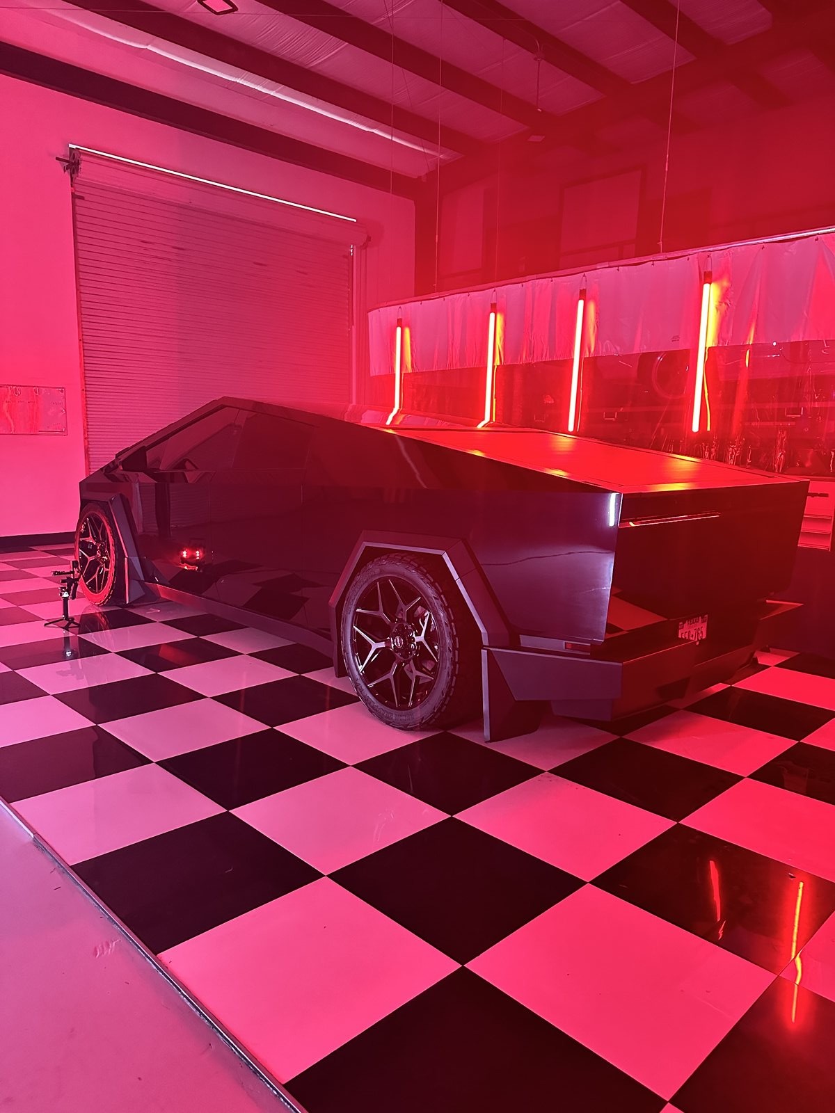 Red Cybertruck under studio lighting at EVS