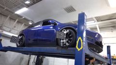 Tesla Model Y on the alignment lift at EVS Motors