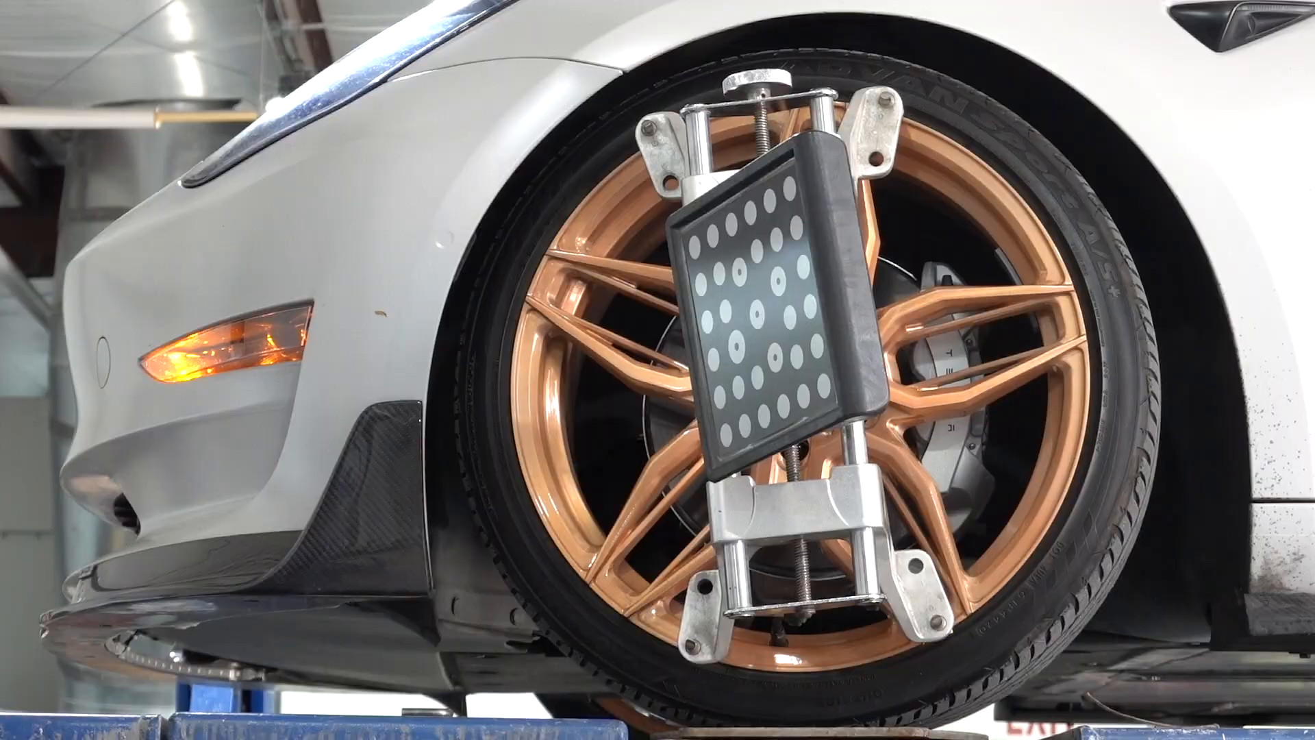Alignment target clamped to a Tesla wheel at EVS Motors