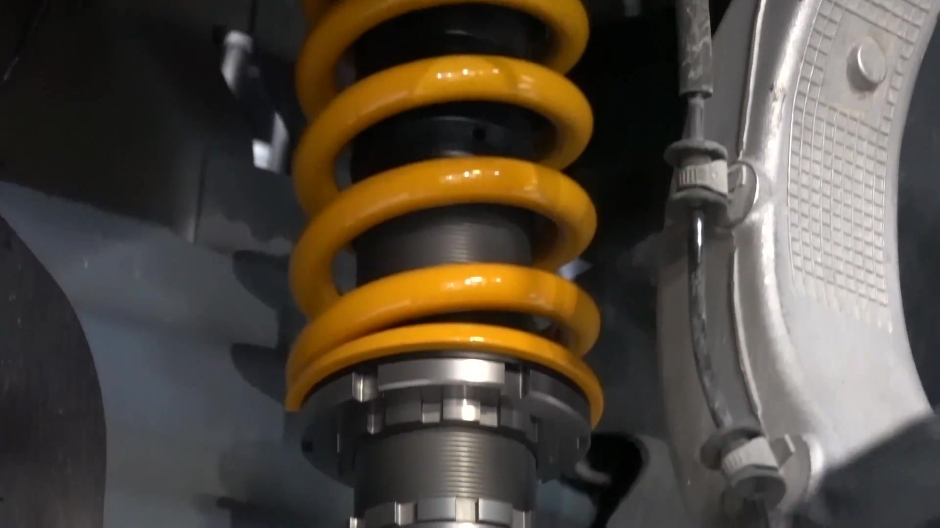 Coilover with a yellow spring installed on a Tesla Model Y